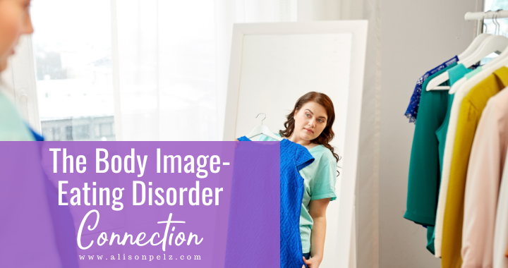 White text over a purple background in the bottom left corner that reads "The Body Image-Eating Disorder Connection". The rest of the image is a photo of a woman holding a dress up to her body in a mirror.